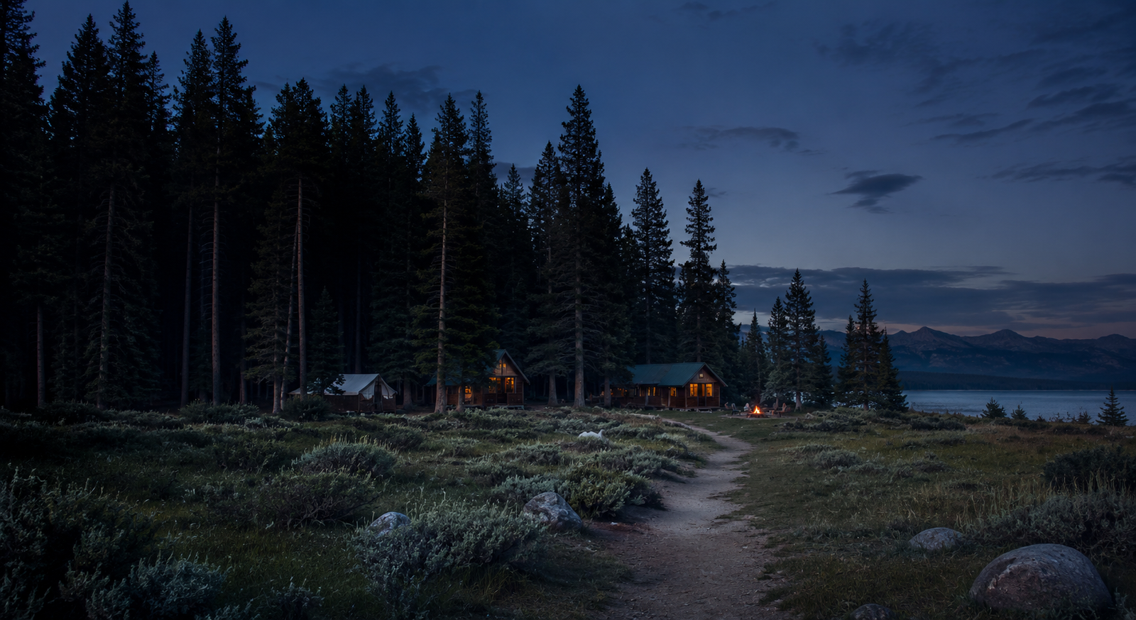 Cabins glowing at dusk beside the lake