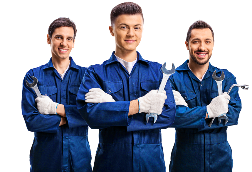Three mechanics in blue overalls, holding wrenches, smiling with crossed arms.