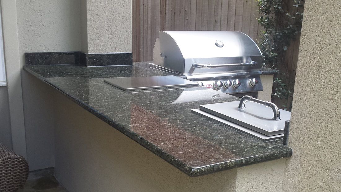 A grill is sitting on top of a granite counter.