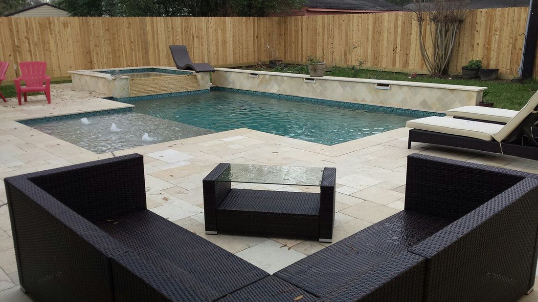 There is a large swimming pool in the backyard with a wooden fence surrounding it.