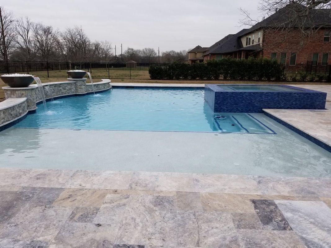 A large swimming pool with a fountain in the middle of it.