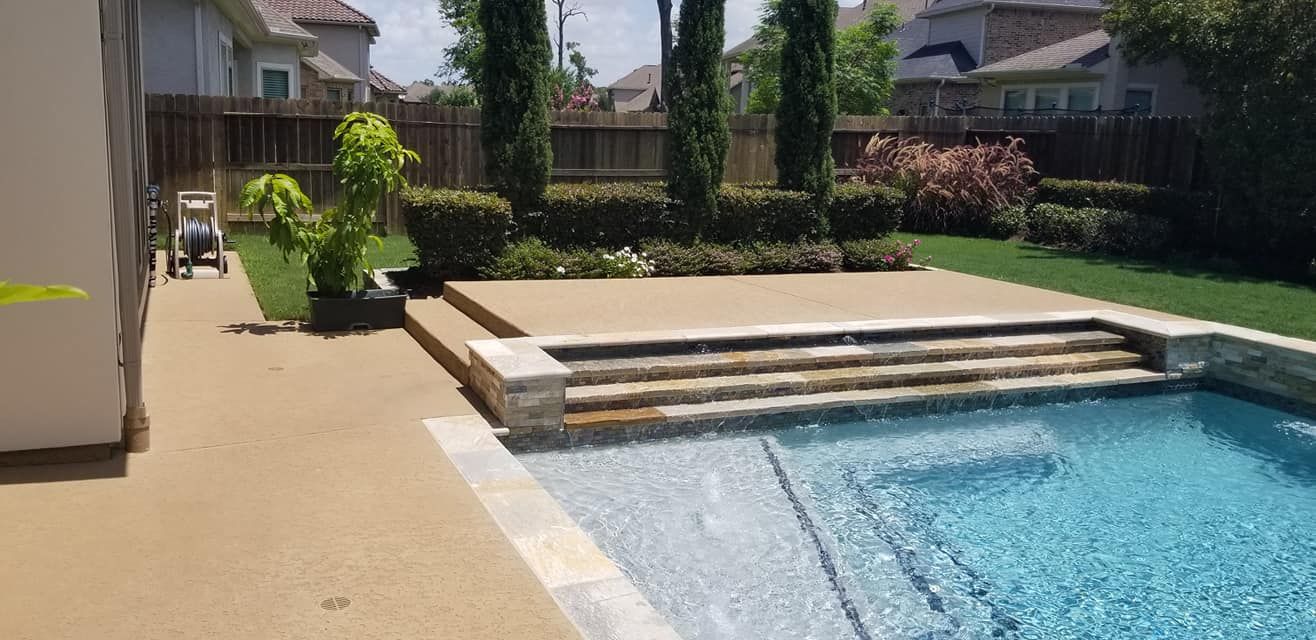 There is a large swimming pool in the backyard of a house.