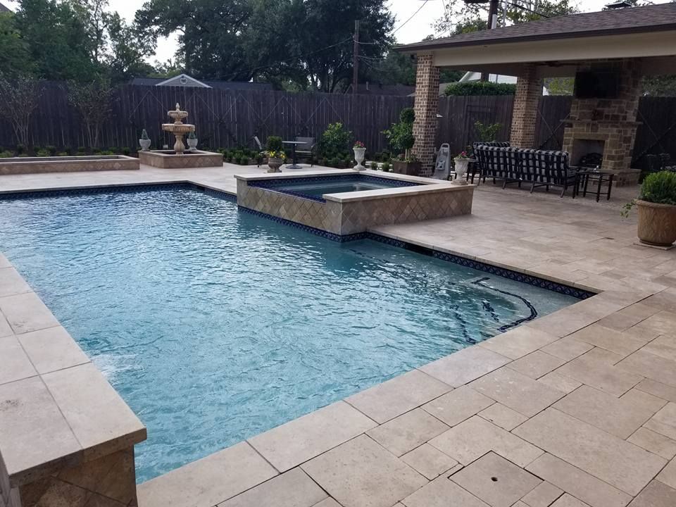 A large swimming pool with a fountain in the middle