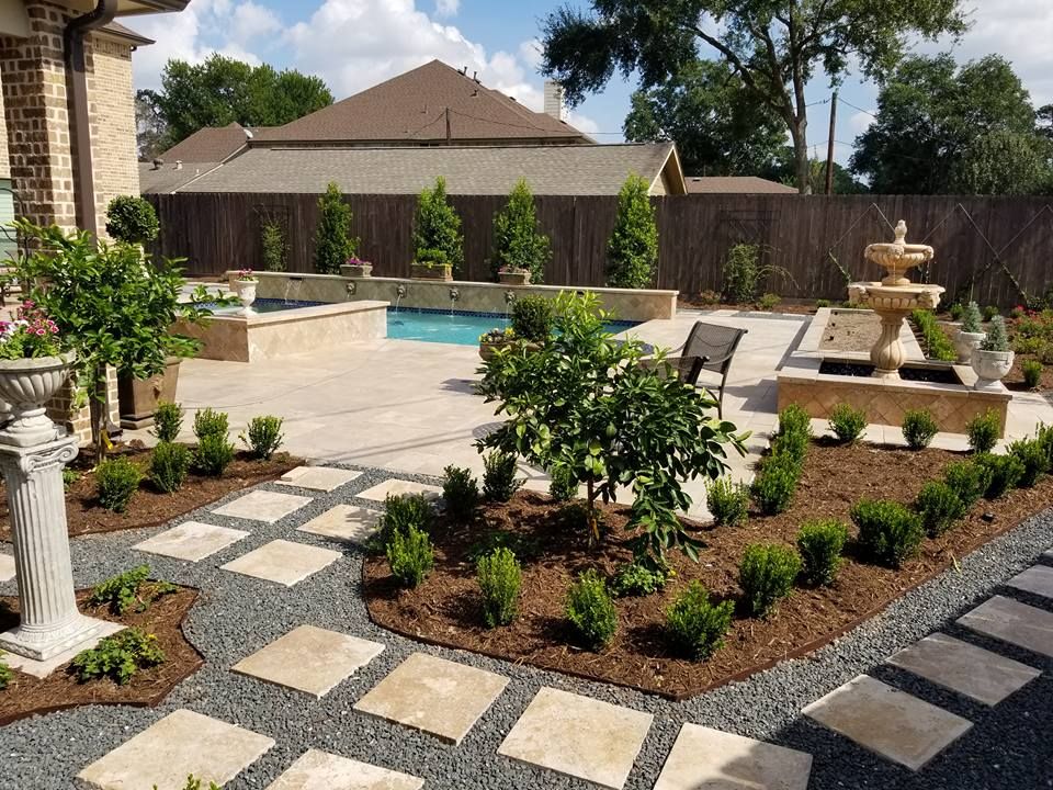A backyard with a swimming pool and a fountain