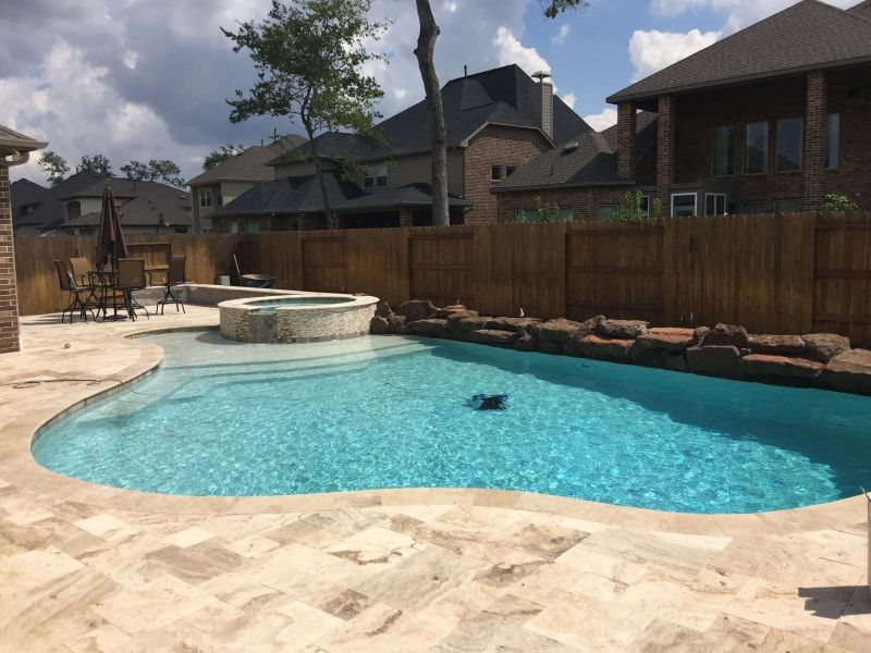 A large swimming pool in the backyard of a house