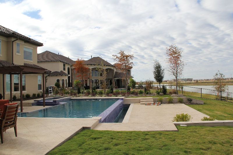 A large house with a large swimming pool in front of it