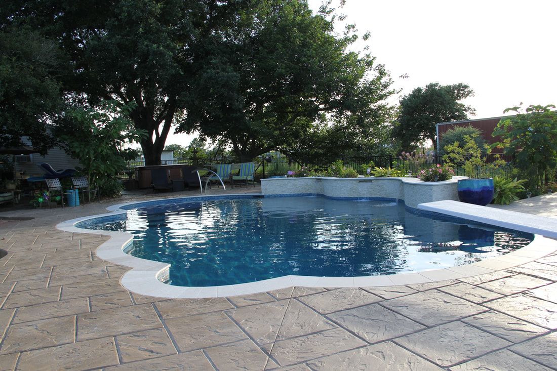 A large swimming pool with trees in the background