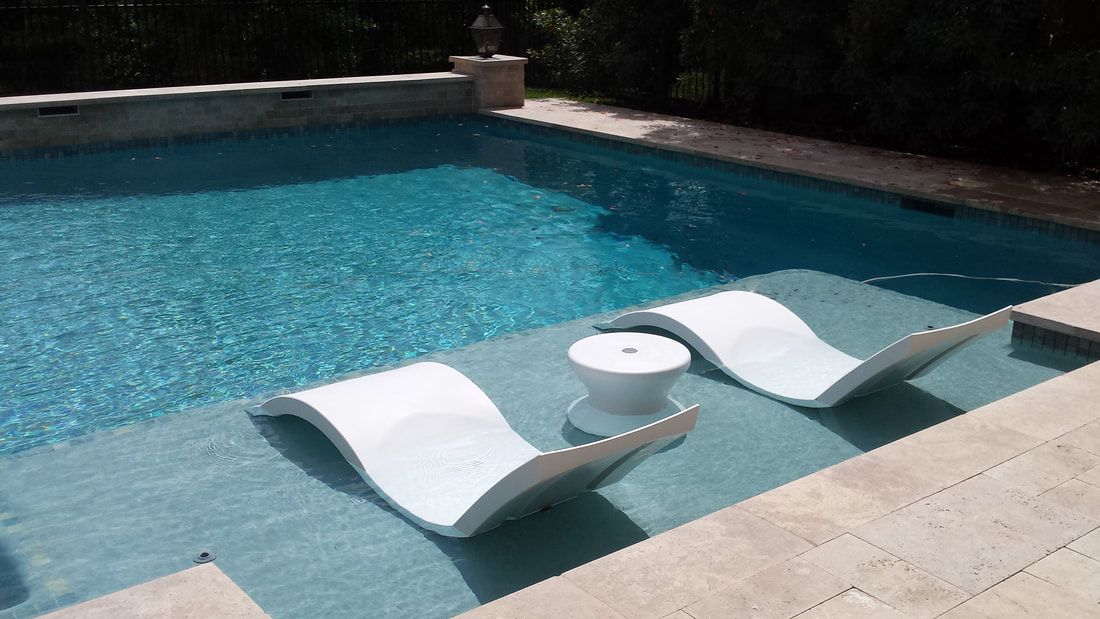 Two white lounge chairs are floating in a swimming pool