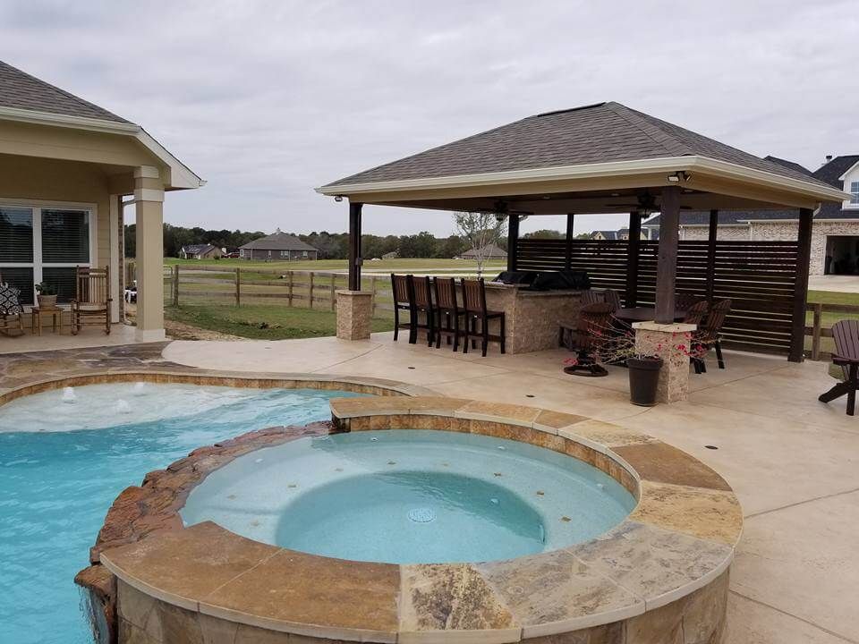 There is a hot tub in the middle of the pool.