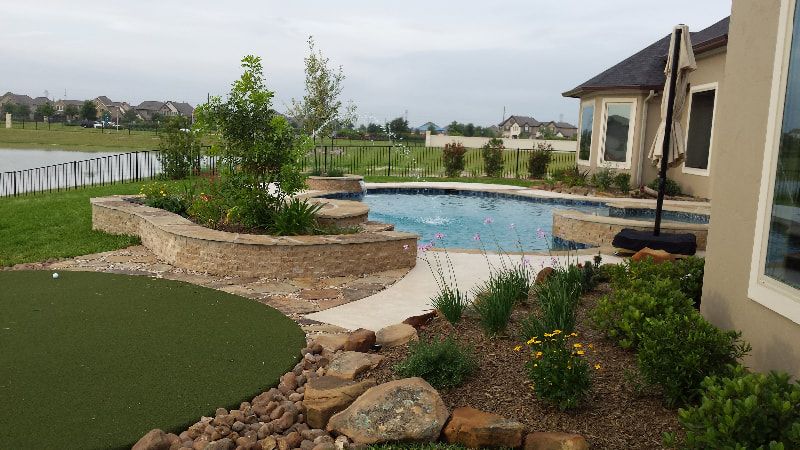 There is a swimming pool in the backyard of a house.