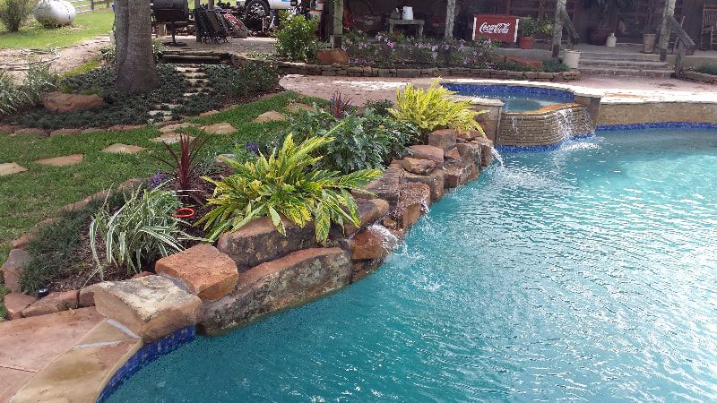 There is a waterfall in the middle of the pool.