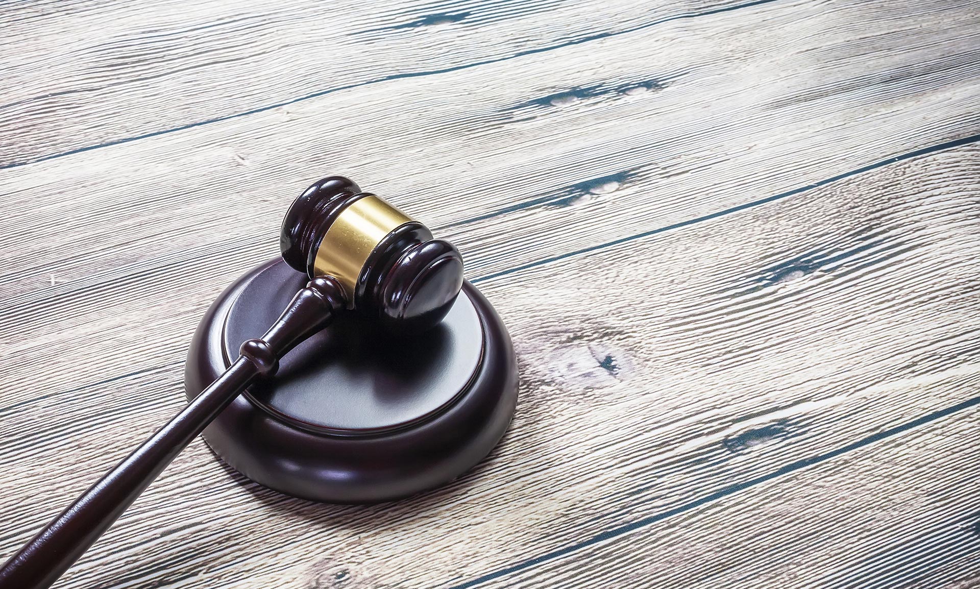 a judge 's gavel is sitting on a wooden table .