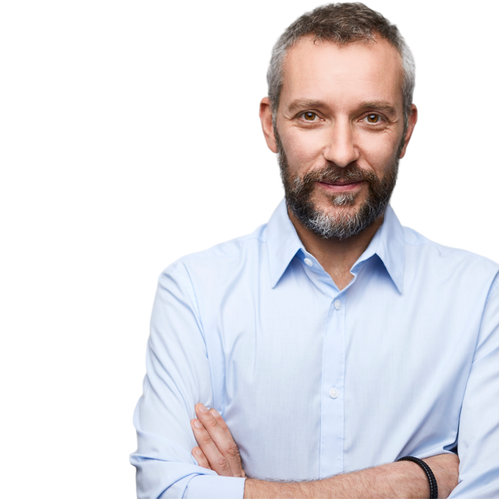 A man with a beard wearing a light blue shirt with his arms crossed