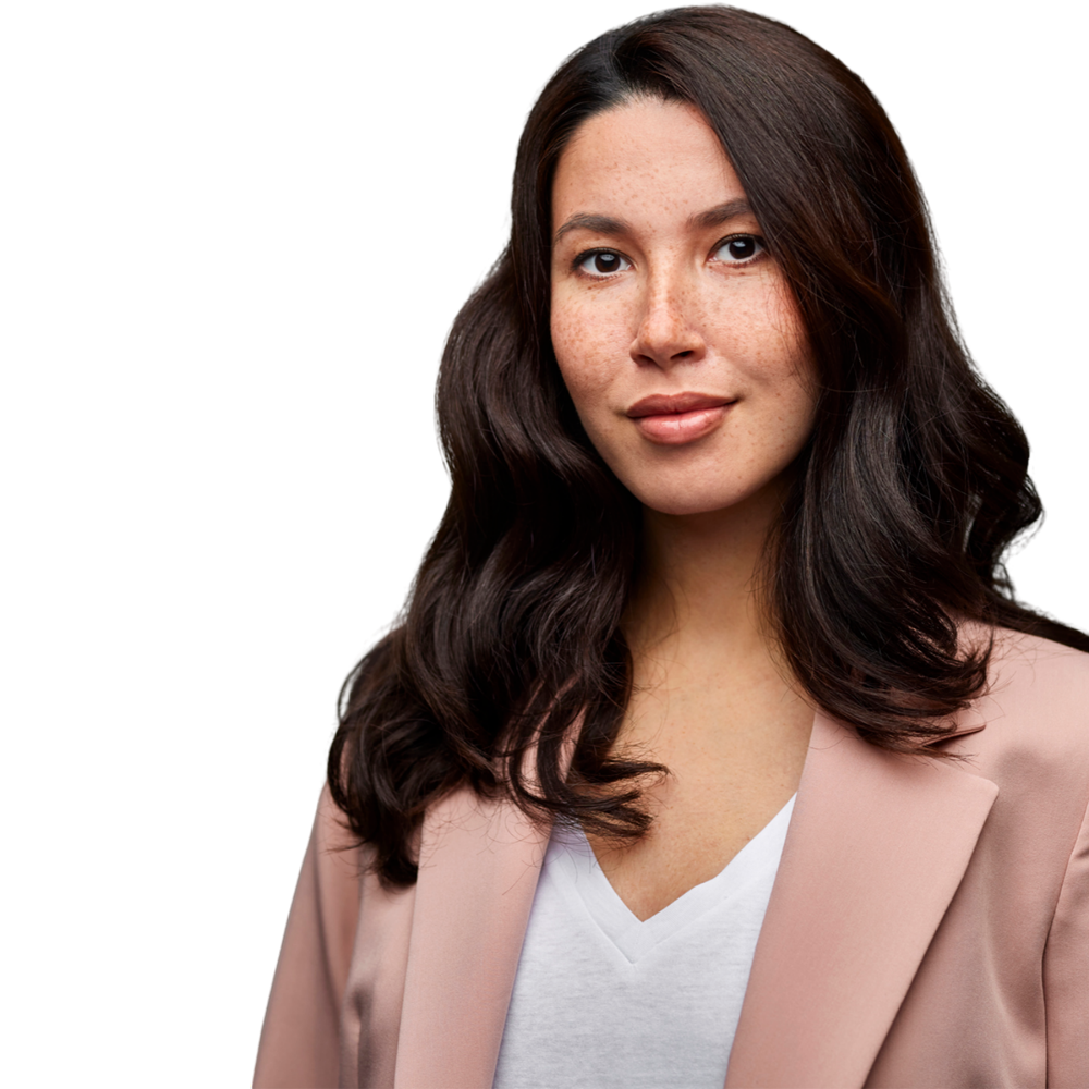 A woman wearing a pink jacket and a white shirt