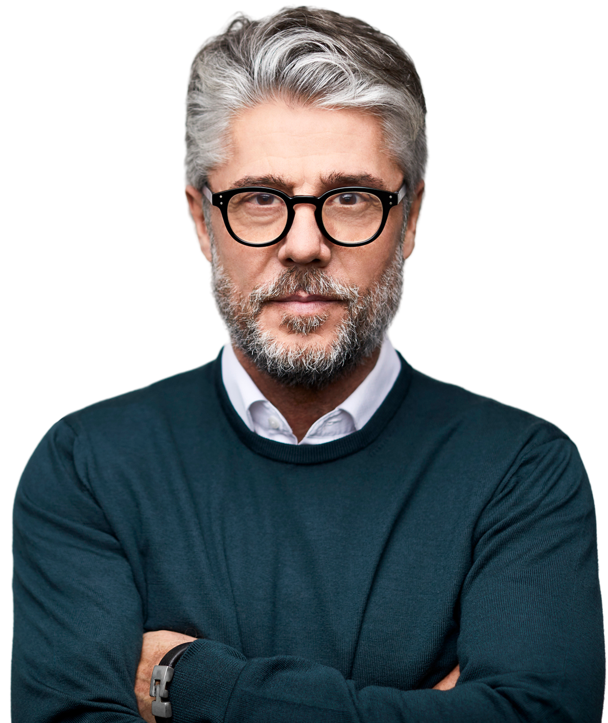 A man with a beard and glasses is standing with his arms crossed.