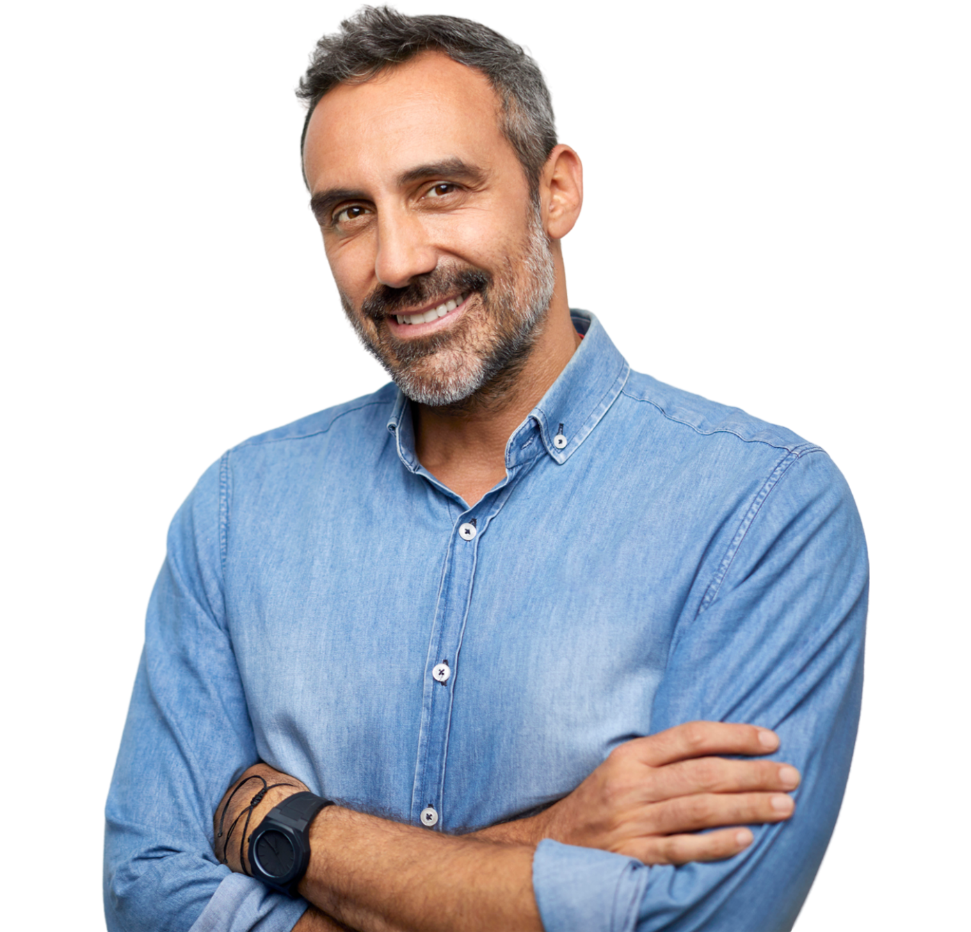 A man in a denim shirt is smiling with his arms crossed