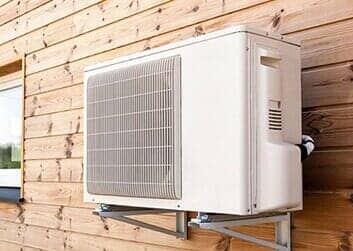 AC on a wooden wall — Air Conditioning Equipment in Faribault, MN