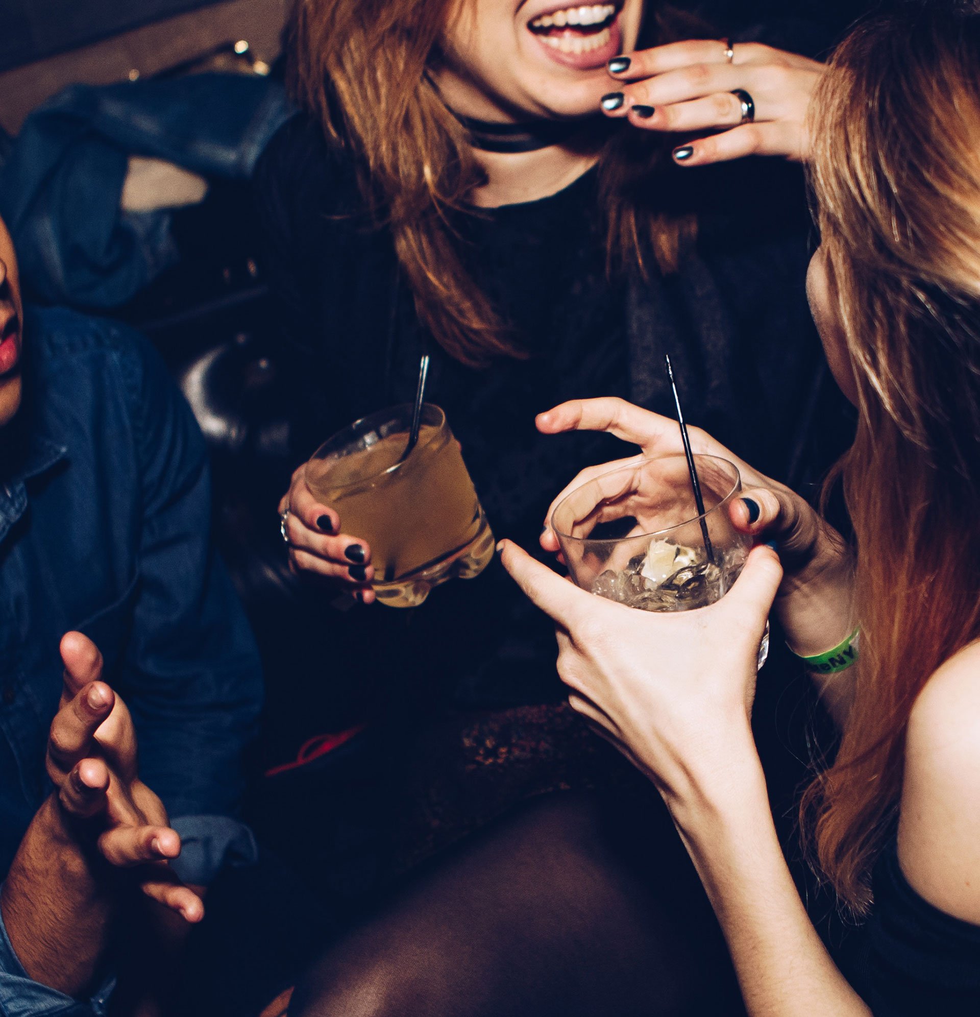 A group of people are drinking and laughing together