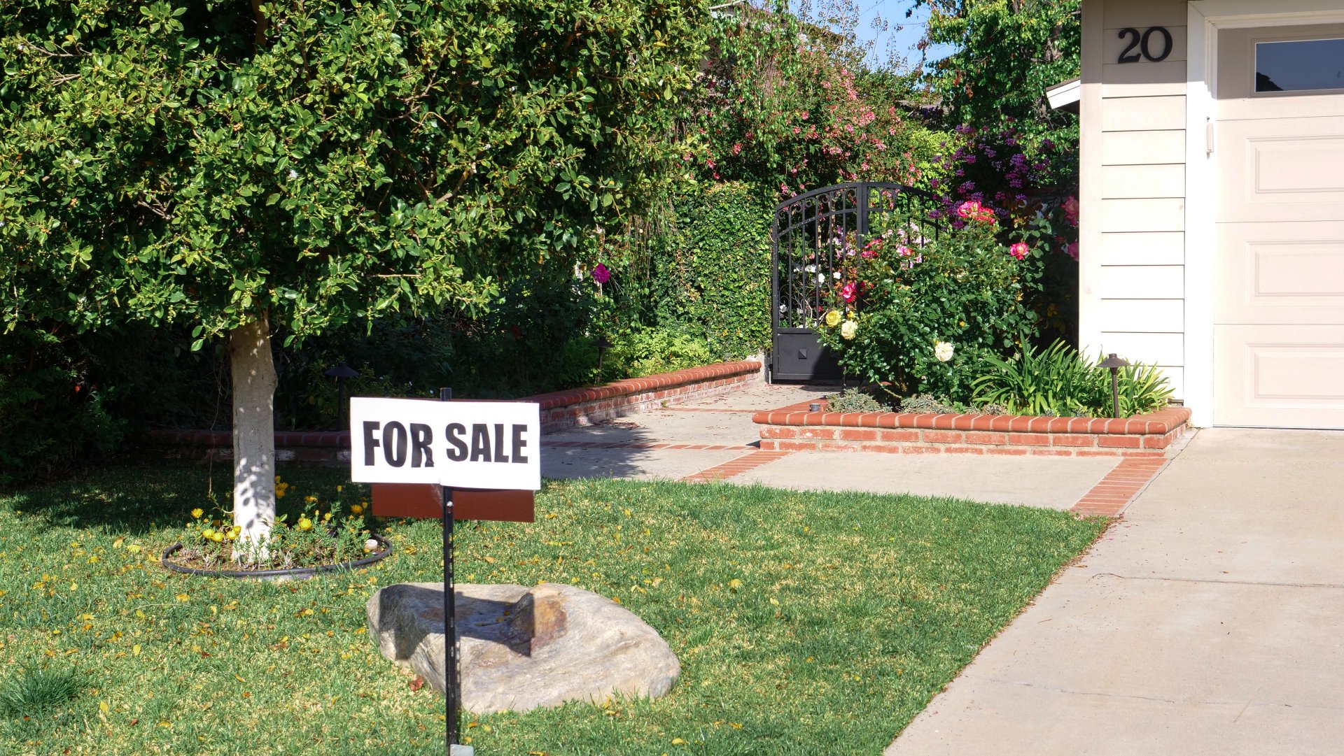 A for sale sign in front of a house